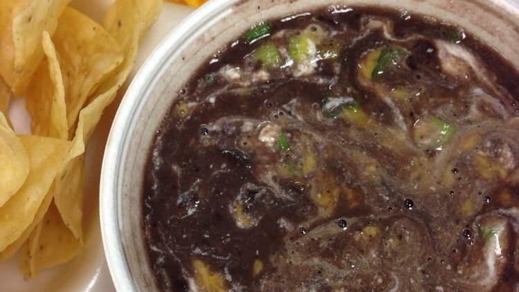 Black Bean Soup · Topped with cheddar cheese, tangy sour cream and fresh green onions.