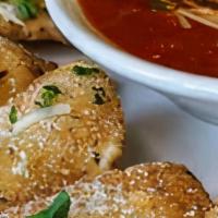 Fried Cheese Ravioli · Cheese ravioli are breaded & fried to a golden brown. Served with a side of marinara.