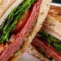 Lucia Panini · Layers of hot capicola, provolone, tomatoes & spinach, served on focaccia bread with pesto m...
