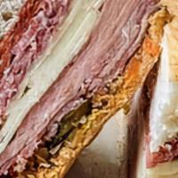 Muffaletta · Served on Muffaletta bread, this best seller starts with a spread of homemade olive tapenade...