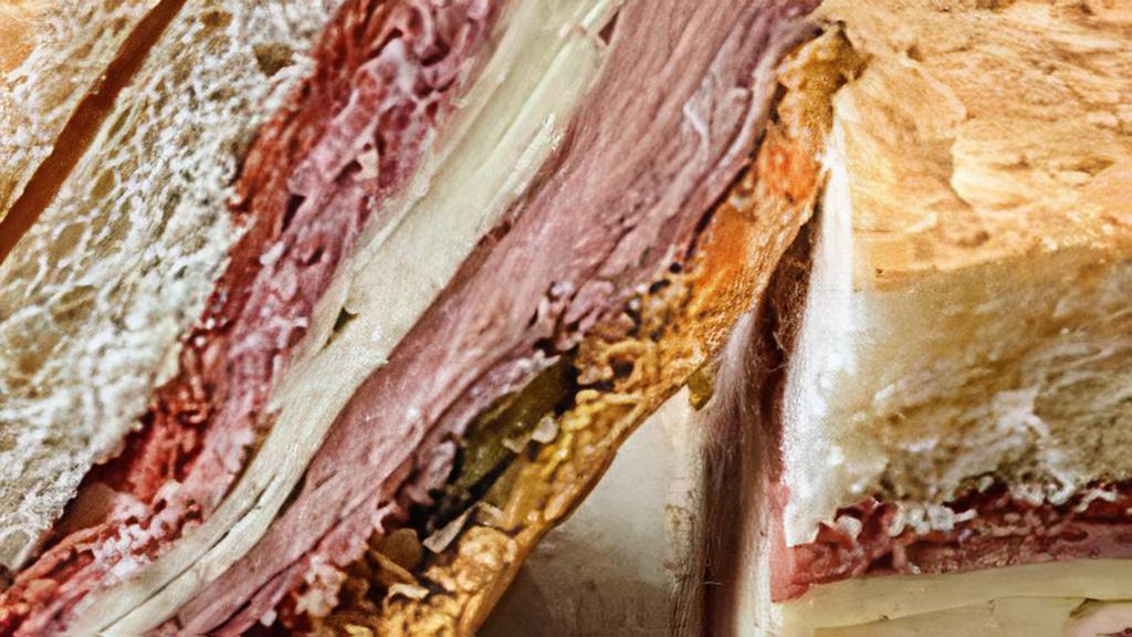 Muffaletta · Served on Muffaletta bread, this best seller starts with a spread of homemade olive tapenade then it’s stacked with hot capicola, genoa salami, ham, mortadella and provolone cheese.