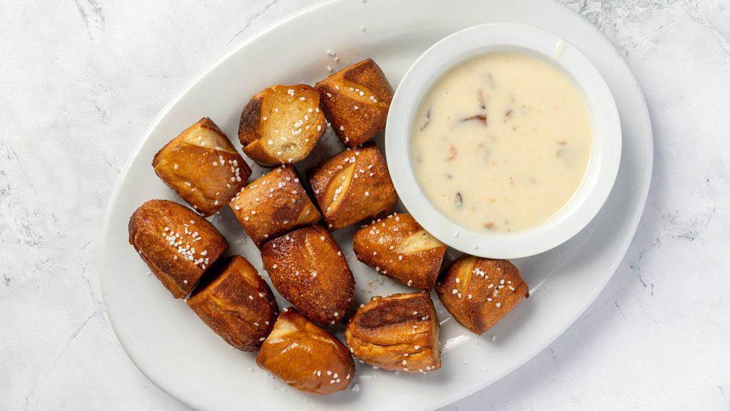 Black Forest Pretzels · Salted pretzel bites served with our house made bacon and smoked gouda cheese dip.