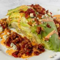 Corner Bar Wedge Salad · Iceberg lettuce topped with bacon jam and our buffalo gorgonzola dressing.