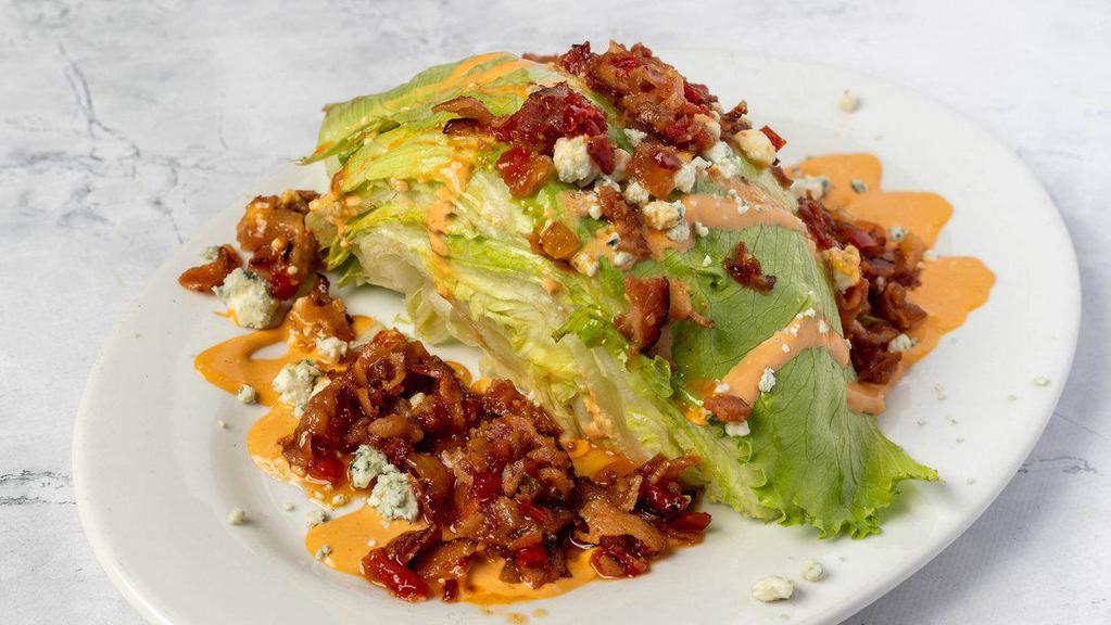 Corner Bar Wedge Salad · Iceberg lettuce topped with bacon jam and our buffalo gorgonzola dressing.