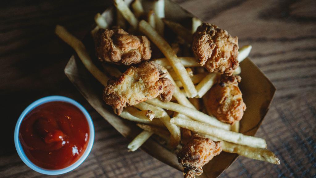 Kids Chicken Nuggets · Served with fries and juice.
