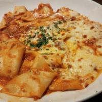 Crazy Lasagna · Free-form, three meat bolognese, pappardelle pasta, mozzarella cheese