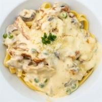 Pasta Milano · Fresh fettuccine noodles with sautéed chicken breast, mushrooms, peas, and our delicious Alf...