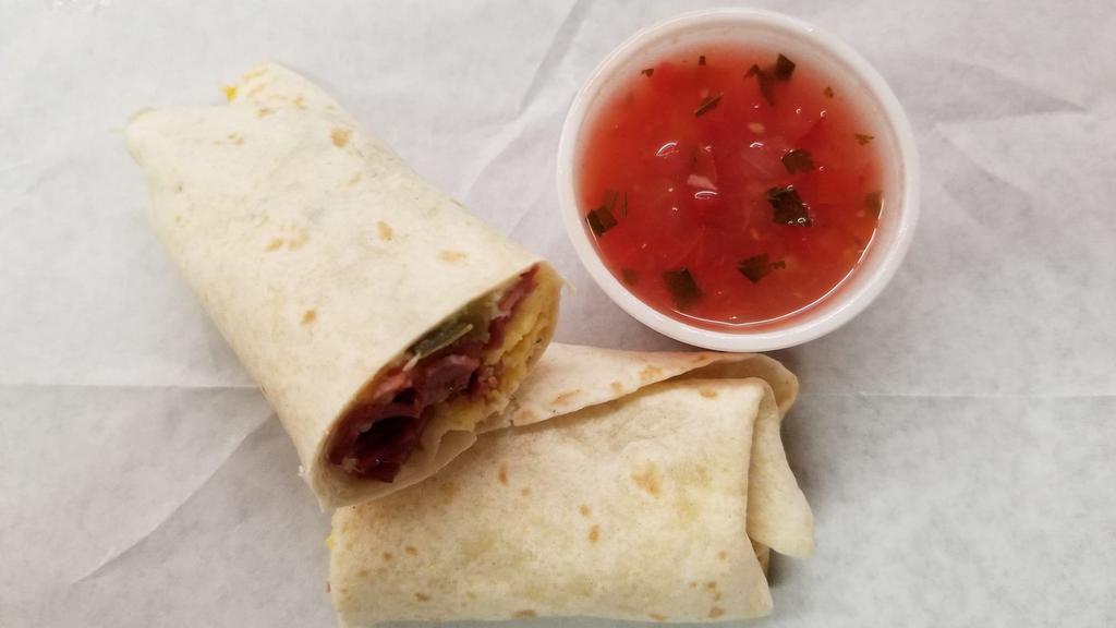 Breakfast Burrito · A soft flour tortilla filled with egg, cheese and your choice of bacon or sausage