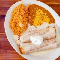 Pollo Fundido · Two chicken burritos fried and topped with queso and sour cream. Served with rice and beans....