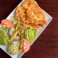 Milanesa · Breaded chicken served with lettuce, onions, jalapeños, tomatoes, avocado, rice, beans, and ...