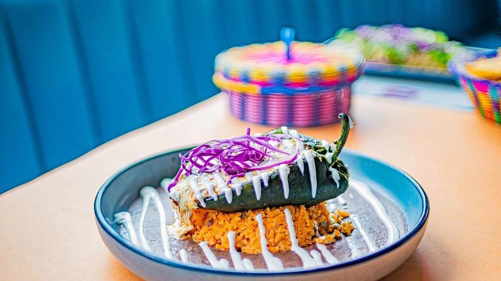 Chile Relleno · poblano pepper stuffed with your choice of picadillo ground beef or chicken tinga, black bean sauce, crema mexicana, oaxaca cheese, rice, microgreens