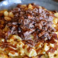 Brisket Mac And Cheese Bowl · mac and cheese topped with smoked brisket, bacon, and a drizzle of Carolina Sweet BBQ Sauce.