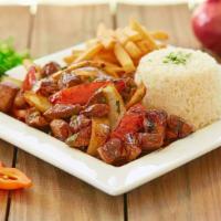 Lomo Saltado (Beef Sautéed) · Tender strips of steak, Roma tomatoes and red onions sautéed & served over french fries with...