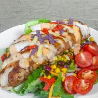 Southwestern Chicken Salad · Smoky BBQ chicken on a bed of mixed greens, roasted corn and black bean salsa, tortilla stri...