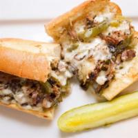 Philly Cheese Steak Sub · Roast beef with sautéed green peppers, onions, mayonnaise, and provolone cheese on a soft ba...