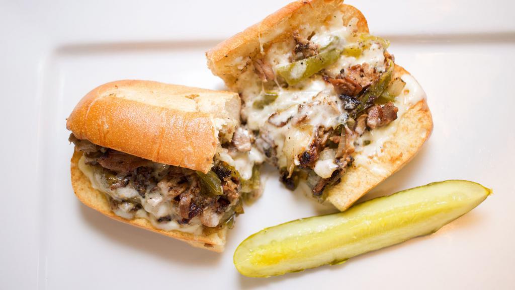 Philly Cheese Steak Sub · Roast beef with sautéed green peppers, onions, mayonnaise, and provolone cheese on a soft baguette.