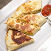 Chicken Quesadilla · With grilled onions, green peppers, cheddar, and mozzarella cheeses. Served with sour cream ...