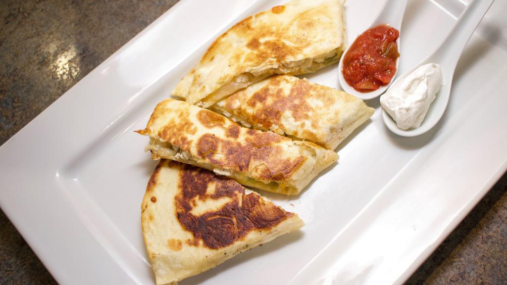 Chicken Quesadilla · With grilled onions, green peppers, cheddar, and mozzarella cheeses. Served with sour cream and salsa.