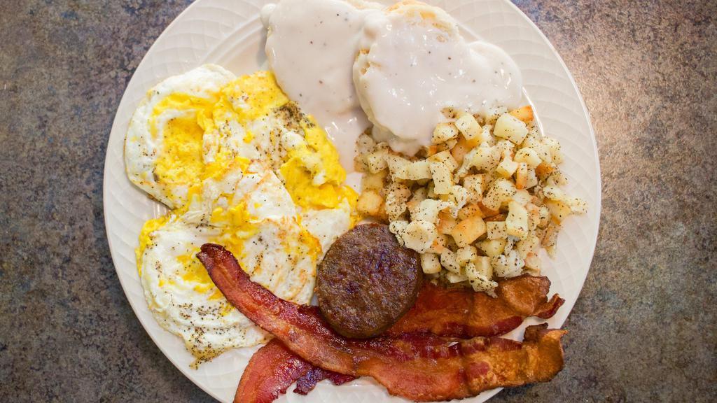 All American Breakfast · Three eggs cooked any style, two strips of bacon, sausage patty, breakfast potatoes or grits, and a biscuit with gravy.