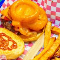 Western Burger · Topped with bacon, onion rings, cheddar cheese, and bbq mayo mixture. Served with a pickle s...