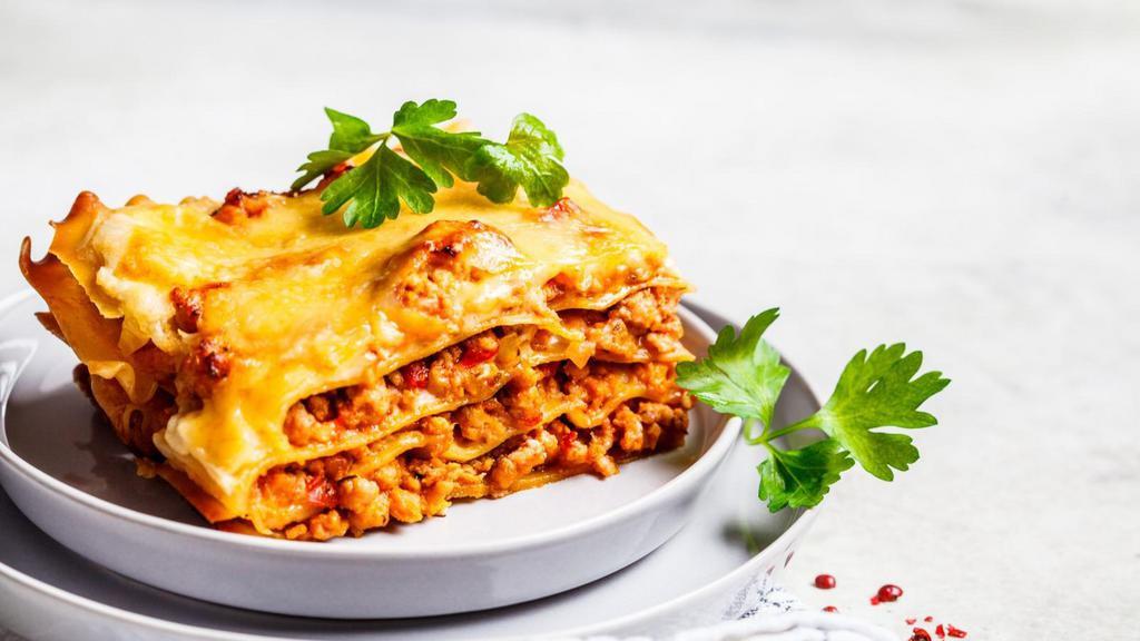 Classic Lasagna · Bubbling layers of pasta, seasoned ground beef, signature marinara sauce, and herbed ricotta topped with mozzarella. Served with customer's choice of bread and salad.
