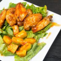 Mango Habanero Wings · Delicious wings sprinkled with special seasonings, tossed in mango habanero sauce, and baked...