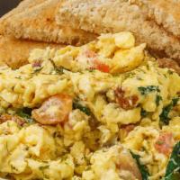 The Bomb · Three eggs scrambled, with grilled spinach, tomato, onion & feta cheese, served with whole w...