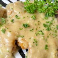Smothered Pork Chop · Pork Chop smothered in gravy served with choice of two sides.