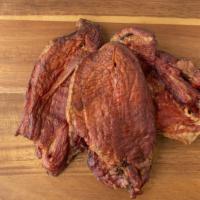 Pork Tasso · Three pieces. Approximately 1 lb. 
95% lean pork roast, sliced then seasoned and smoked. Gre...