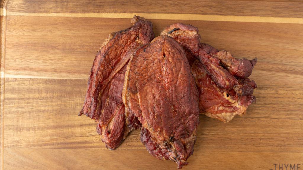 Pork Tasso · Three pieces. Approximately 1 lb. 
95% lean pork roast, sliced then seasoned and smoked. Great as seasoning meat in many dishes, or as a ready-to-eat snack.