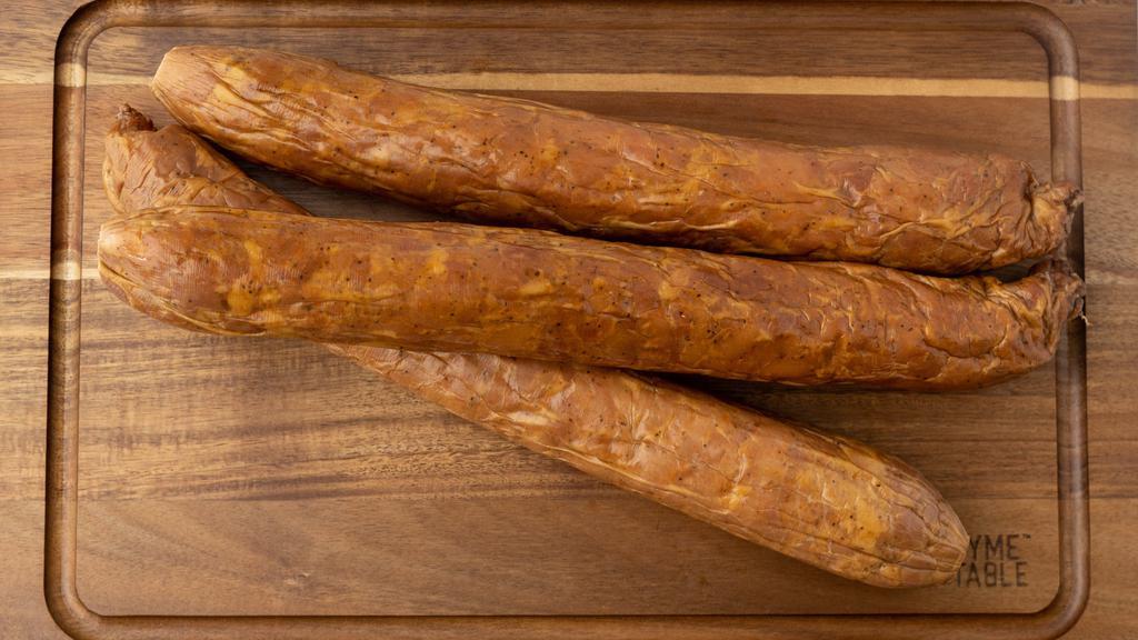 Chicken Andouille · One Stick. Approximately 1.5 lbs. 
Our signature product is a type of smoked sausage in which choose chicken meat. Is cubed rather than ground, seasoned with a little more salt, red pepper, black pepper, and garlic, then stuffed into a larger beef casing. It is excellent to use for seasoning gumbos, jambalayas, beans, and many other dishes.
