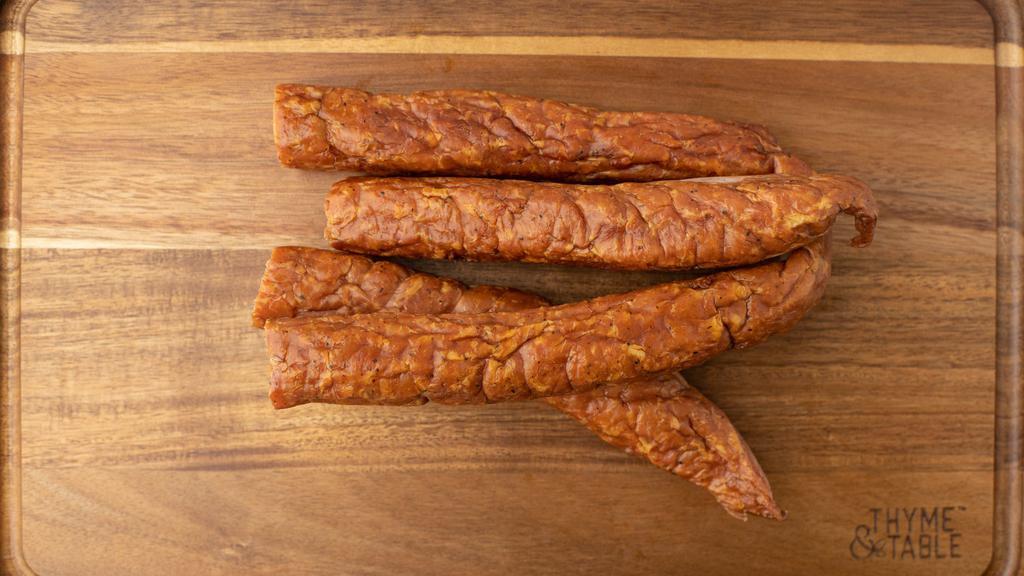 Smoked Chicken Sausage · One pack. Approximately 1.25 lbs. 
Our own chicken sausage blend of ground pork seasoned with salt, red pepper, black pepper, and garlic then stuffed in the traditional pork casing, which is then smoked to fully cooked perfection over aged pecan wood. Great tasting as a snack; and excellent to cook with.