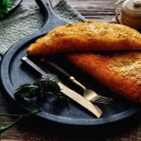 Italian Calzone · Folded pie made with fresh dough, and stuffed with a blend of cheeses, pepperoni, sautéed on...
