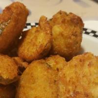 Fried Pickle Chips · Hand-breaded thinly sliced pickle chips fried crispy, served with homemade ranch dressing.