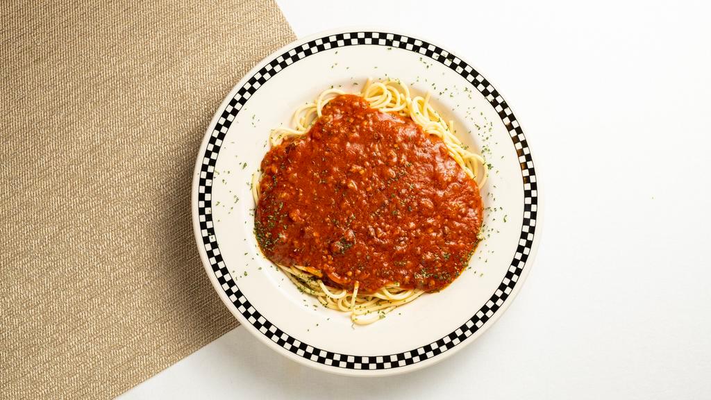 Spaghetti · A mound of tender spaghetti covered with meat or marinara sauce.