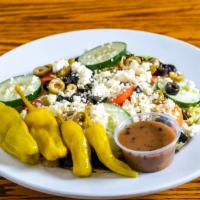 Greek Salad · Black and green olives, whole pepperoncini peppers, cucumbers, feta cheese and tomatoes.