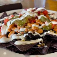 Half Order Nachos · Gluten-free. Seasoned black and pinto beans, vegan queso, salsa verde, tomatoes, red onions,...