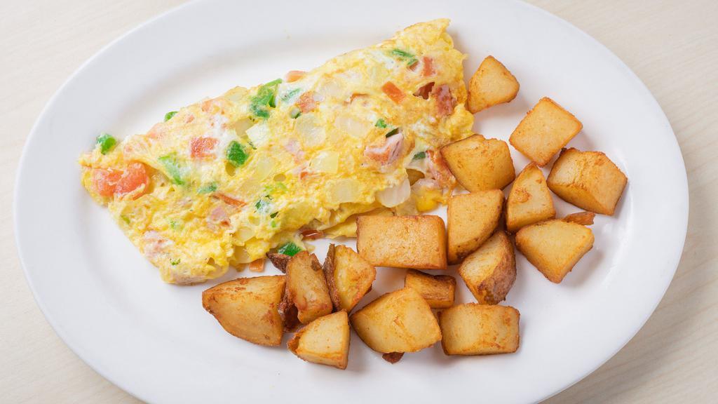 Western Omelet · Ham, onions, peppers, tomatoes & cheese.
