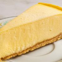 New York Cheese Cake · New York cheesecake flavored with a hint of bourbon vanilla, on a sponge cake base.