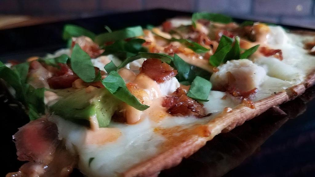 The Man Pie Flatbread · Marinara base with blend cheeses, pepper jack cheese, basil, BBQ chicken, pepperoni, salami and bacon.