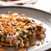 Chana Chaat · Chickpeas and flour crisps served with yogurt, tamarind, mint chutney, topped with chopped t...