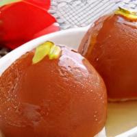 Gulab Jamun · Sweet pastry balls in warm honey flavored syrup garnished with raisins can be served creamy.