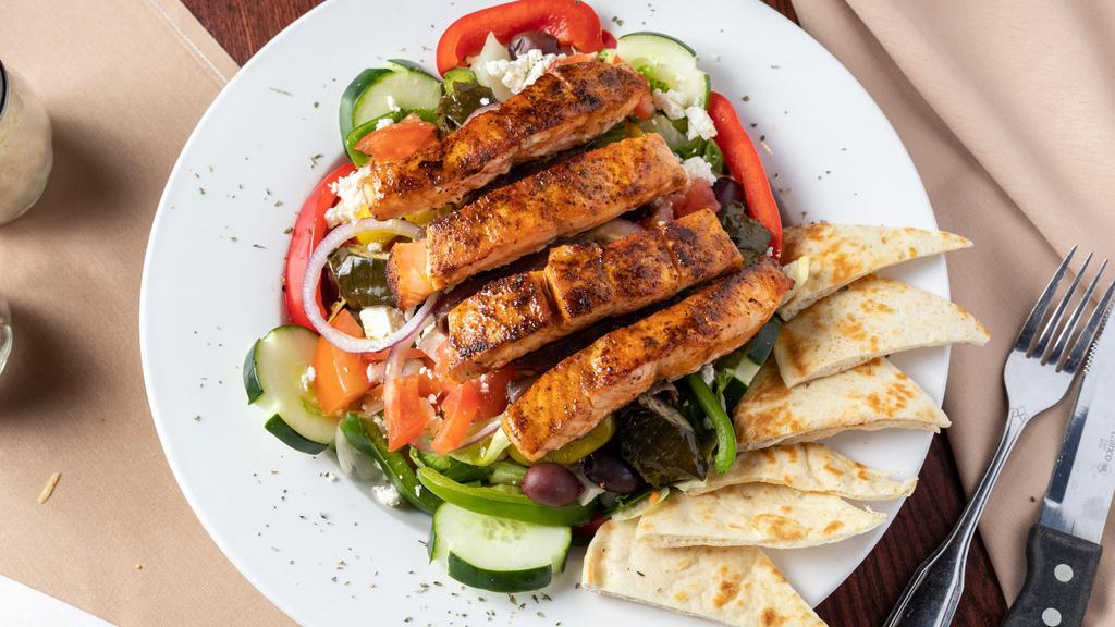 Spiro'S Greek Salad · Fresh Chopped Lettuce, Tomato, Cucumber, Red Onion, Bell Pepeprs, Pepperoncinis, Feta, Kalamata Olives, Dolmades (Rice Stuffed Grape Leaves), Anchovies, Grilled Pita.