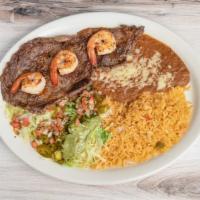 Steak With Shrimp · Grilled jumbo shrimp over rib-eye steak. Served with rice, beans and guacamole salad.