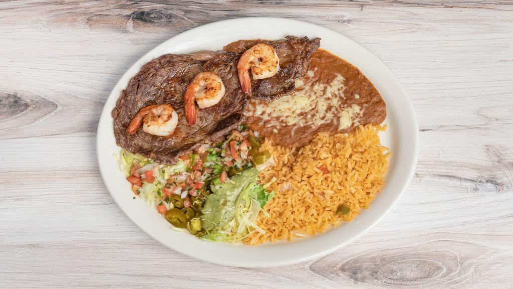 Steak With Shrimp · Grilled jumbo shrimp over rib-eye steak. Served with rice, beans and guacamole salad.