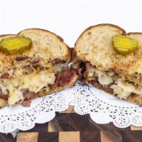 Reuben · Corned Beef, Sauerkraut, and melted Swiss Cheese off the grill served on toasted Rye with a ...