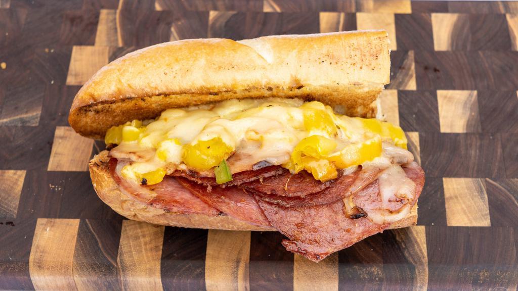 The Italian · Salami, Beef Pepperoni, Ham, Hot Pepper Cheese, Banana Peppers and Oil & Vinegar grilled on a toasted roll.