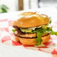 Wild Caught Salmon Burger · A fresh salmon party with just a hint of lemon and spices. Topped with our homemade caper di...