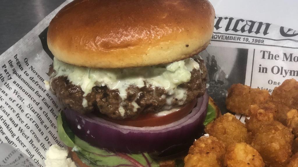 The Greek Burger · Crumbled feta cheese, red onion, spring mix, tomato, drizzled with tzatziki sauce & Mediterranean seasoning.