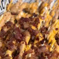 Bacon And Cheese Loaded Fries · French fries topped with crispy bacon, American cheese, and drizzled with creamy chipotle ra...